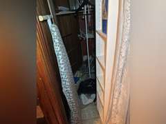 Contents of closet in entertainment room, (small six shelf cabinet with glass display case, walker a