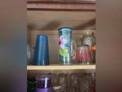 Top shelf of cabinet-Tupperware pitchers and glasses