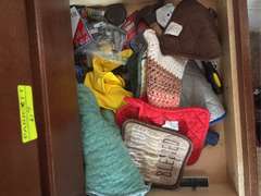 Bottom two drawers of kitchen cabinet (tools, oven rags, and plastic ware)