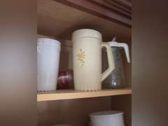 Top shelf of cabinet-Tupperware pitchers and glasses