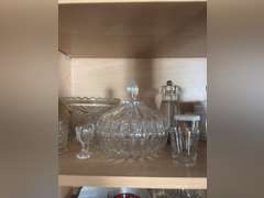 Shelf of glassware ( eye washer, covered candy, toothpick holder, and other glassware