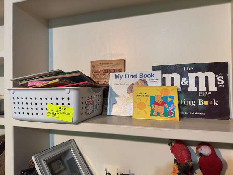 Shelf of various old books & newspaper