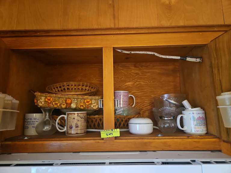 Shelf of miscellaneous china, mugs, Tupperware spice holders, and ...