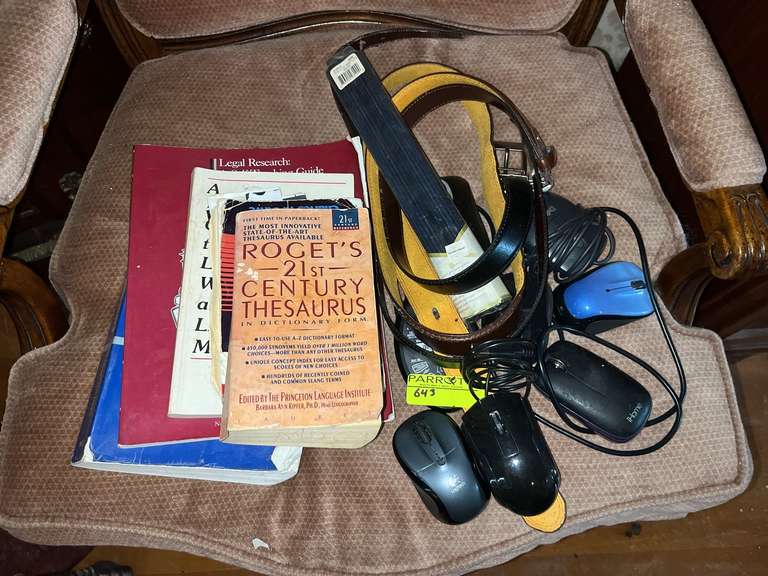 Computer mice, books, belt and more on chair