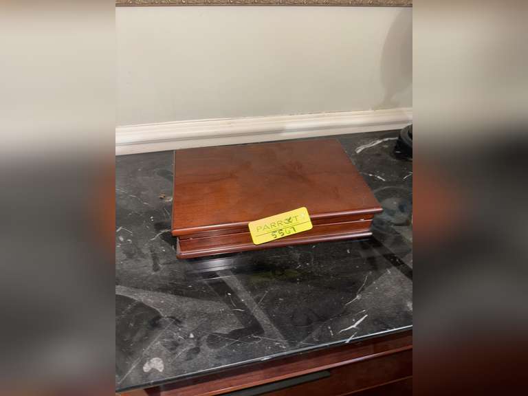 Contents of Table (wooden case with card set, Marvin the Martian stone figure, BMW Neon Sign, and Mo