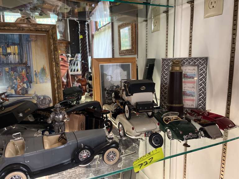 Shelf of model cars and other decorations