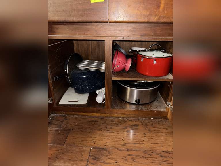 Contents of cabinet (pots, roaster pan, and crock)