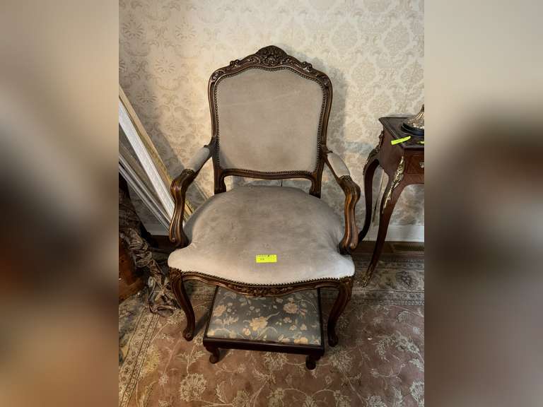 Carved upholstered side chair with foot stool