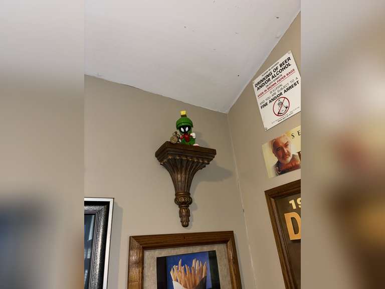 Various framed pictures w/decorative items on north-east wall