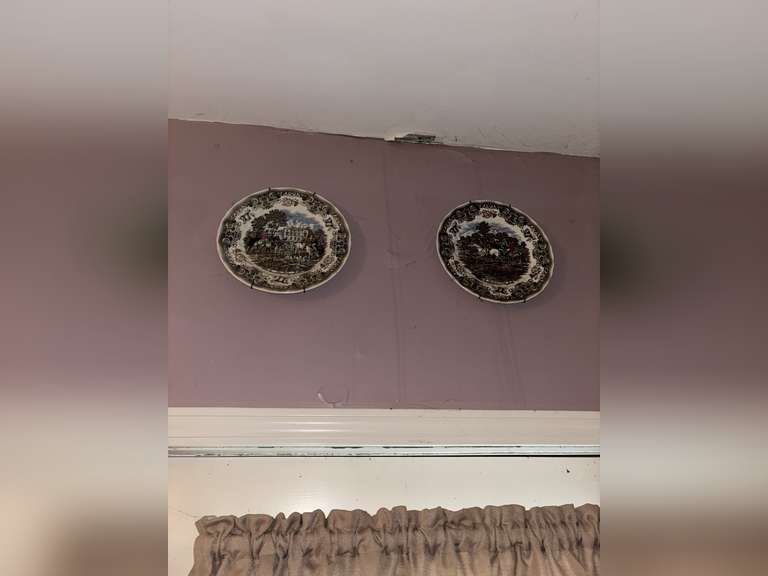 2 hung decorative plates with framed jockey pieces