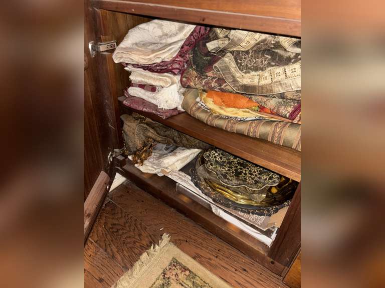 2 shelves of table cloths and runners