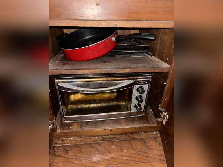 Contents of drawer and cabinet (microwave, pans, and kitchen rags)