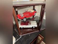 Contents of Table (wooden case with card set, Marvin the Martian stone figure, BMW Neon Sign, and Mo