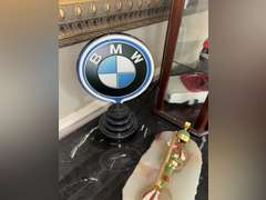Contents of Table (wooden case with card set, Marvin the Martian stone figure, BMW Neon Sign, and Mo