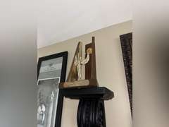 Various framed pictures w/decorative items on north-east wall