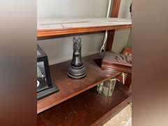 Contents of Table (wooden case with card set, Marvin the Martian stone figure, BMW Neon Sign, and Mo