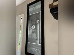 Various framed pictures w/decorative items on north-east wall