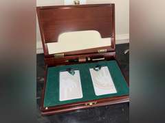 Contents of Table (wooden case with card set, Marvin the Martian stone figure, BMW Neon Sign, and Mo