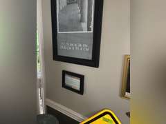 Various framed pictures w/decorative items on north-east wall