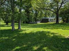 Home with Walk-Out Basement & Outbuildings on 5+/- Acres