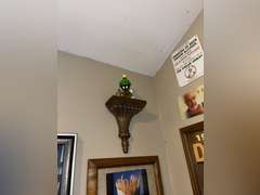 Various framed pictures w/decorative items on north-east wall