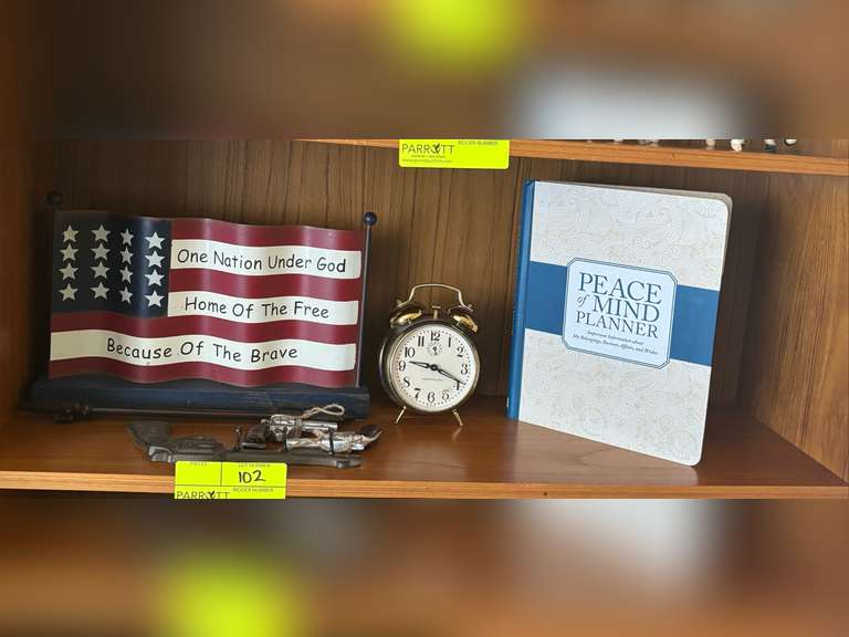 Shelf of American flag decor, clock, and Planner