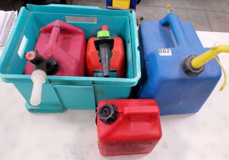 4 Asst. Gas Cans & Plastic Crate. All for one money.