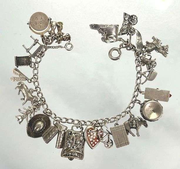 Wonderful Vintage 7" Sterling Charm Bracelet with Approx. 21 Charms.  49.7 grams total weight. This is an incredibly fun piece to look at.