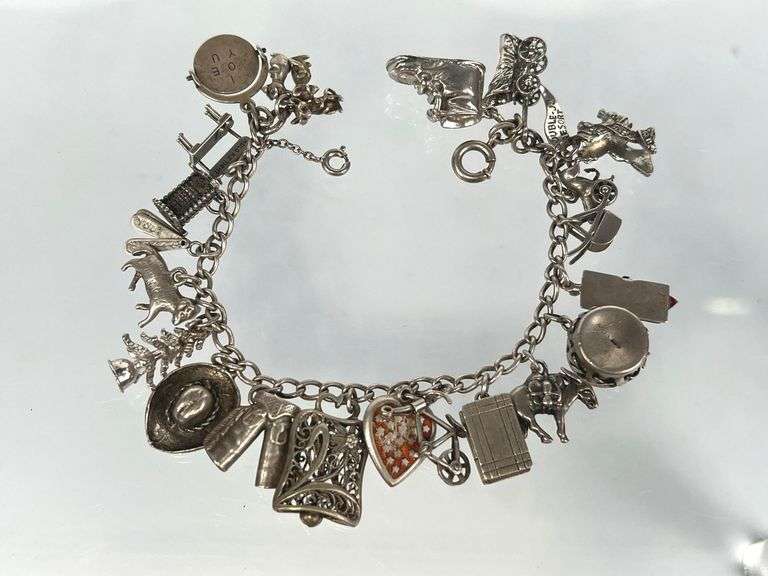 Wonderful Vintage 7" Sterling Charm Bracelet with Approx. 21 Charms.  49.7 grams total weight. This is an incredibly fun piece to look at.