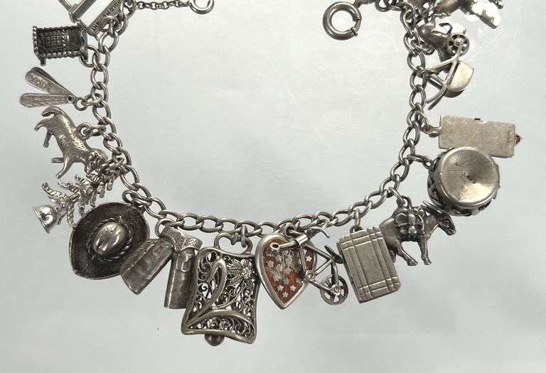 Wonderful Vintage 7" Sterling Charm Bracelet with Approx. 21 Charms.  49.7 grams total weight. This is an incredibly fun piece to look at.