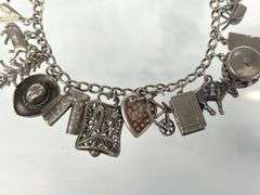 Wonderful Vintage 7" Sterling Charm Bracelet with Approx. 21 Charms.  49.7 grams total weight. This is an incredibly fun piece to look at.