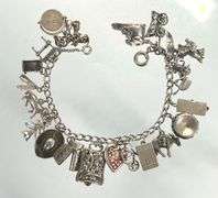 Wonderful Vintage 7" Sterling Charm Bracelet with Approx. 21 Charms.  49.7 grams total weight. This is an incredibly fun piece to look at.