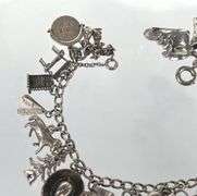Wonderful Vintage 7" Sterling Charm Bracelet with Approx. 21 Charms.  49.7 grams total weight. This is an incredibly fun piece to look at.