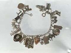 Wonderful Vintage 7" Sterling Charm Bracelet with Approx. 21 Charms.  49.7 grams total weight. This is an incredibly fun piece to look at.
