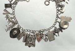 Wonderful Vintage 7" Sterling Charm Bracelet with Approx. 21 Charms.  49.7 grams total weight. This is an incredibly fun piece to look at.