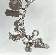 Wonderful Vintage 7" Sterling Charm Bracelet with Approx. 21 Charms.  49.7 grams total weight. This is an incredibly fun piece to look at.
