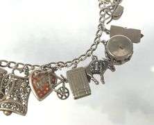 Wonderful Vintage 7" Sterling Charm Bracelet with Approx. 21 Charms.  49.7 grams total weight. This is an incredibly fun piece to look at.