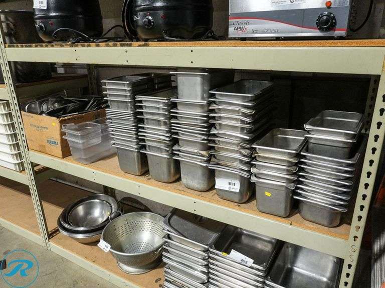 Shelf of Stainless Steel and Plastic Inserts With Box of Lids