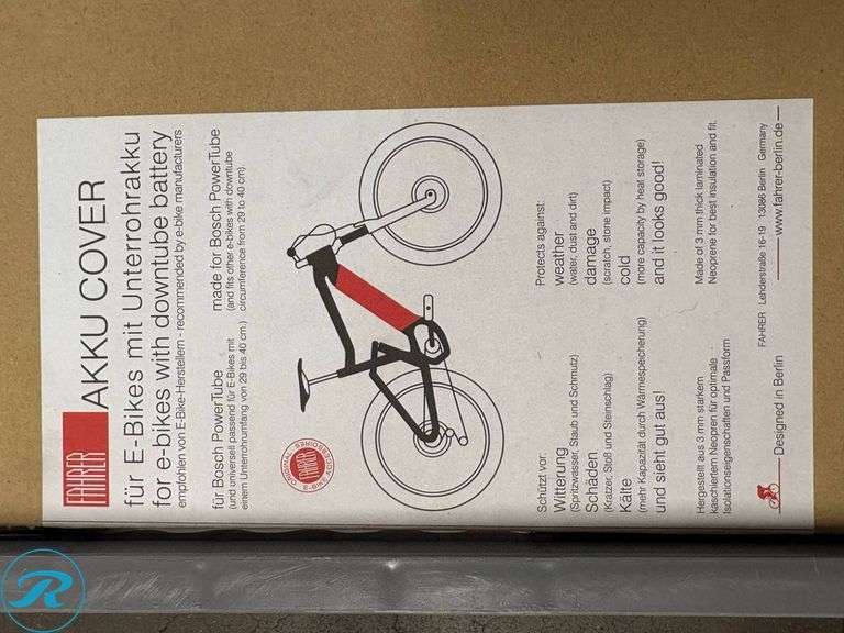 Crate Containing E-Bike Accessories Including Giant Battery Cover, AKKU Bike Covers, and Tire Size Chart - Roller Auctions