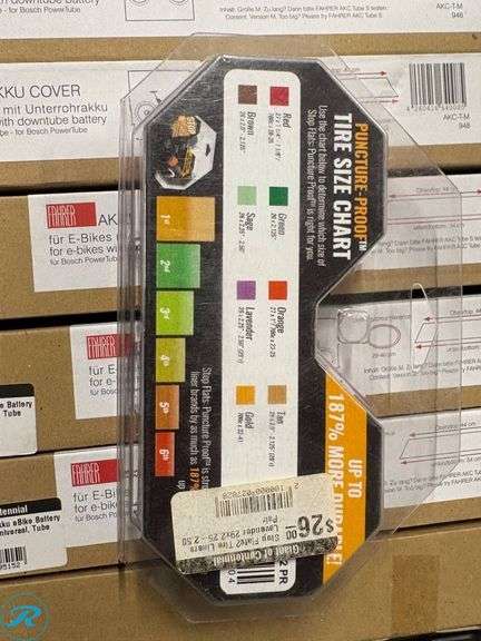 Crate Containing E-Bike Accessories Including Giant Battery Cover, AKKU Bike Covers, and Tire Size Chart - Roller Auctions