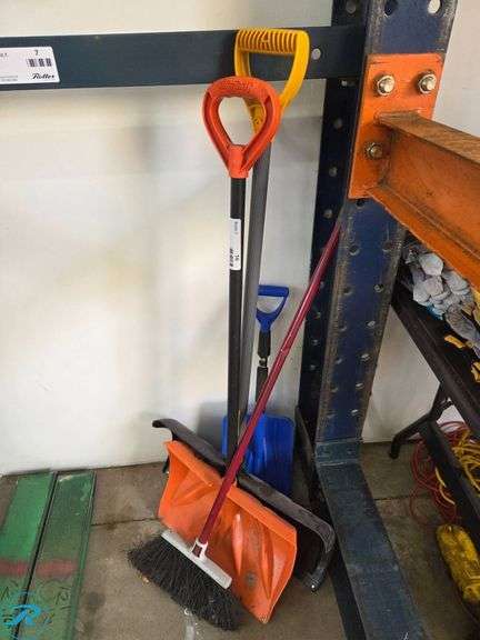 Assorted Cleaning Tools Including Snow Shovel, Broom, and Standard Shovel