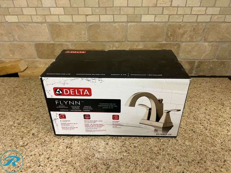 (1) New- Delta Flynn Stainless 4-in Centerset 2-handle WaterSense Mid-arc Residential Handle Bathroom Sink Faucet with Drain - Roller Auctions