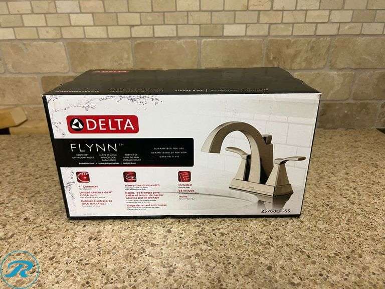 (1) New- Delta Flynn Stainless 4-in Centerset 2-handle WaterSense Mid-arc Residential Handle Bathroom Sink Faucet with Drain - Roller Auctions