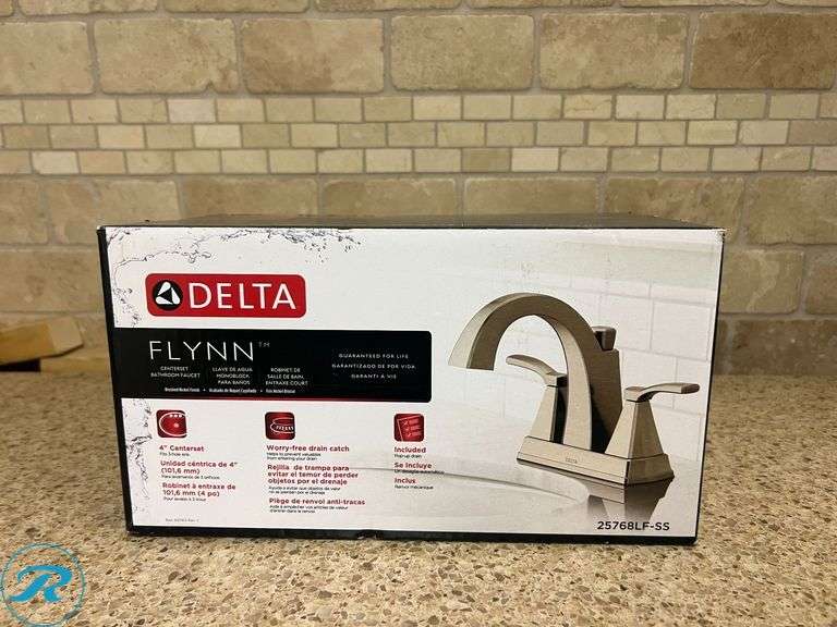 (1) New- Delta Flynn Stainless 4-in Centerset 2-handle WaterSense Mid-arc Residential Handle Bathroom Sink Faucet with Drain - Roller Auctions