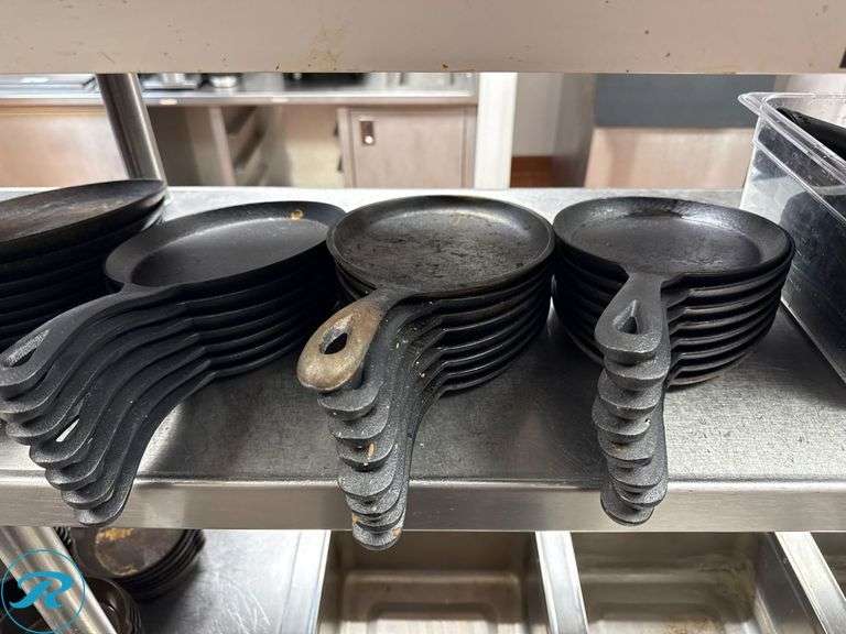(31) Cast Iron Skillets and (60) Wooden Serving Trays - Roller Auctions