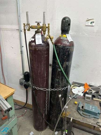 (2) Compressed Gas Cylinders With Regulator (1 Empty, 1 Partial With Argon)