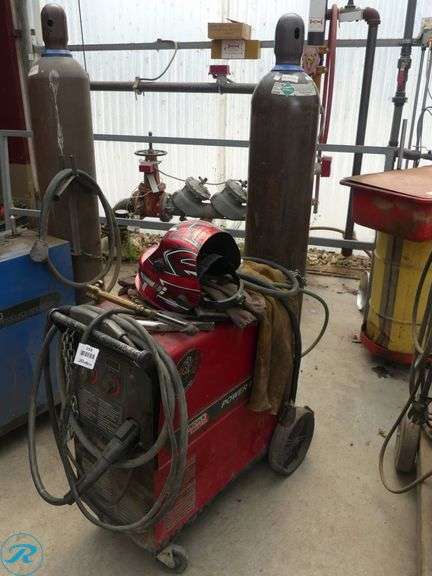 Lincoln Electric Power MIG 255 Mig Welder with Gas Cylinders and Helmet, 208/230V, Single Phase - Roller Auctions