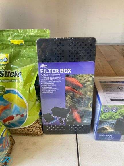 (7) New- (5) Tetra 1lb goldfish and koi 11.25" x 9.5" x 4.75 in green fish food (1) smart pond 12.3" x 63" x 63" black plastic pond pump filter box (1) Pennington 1000 gph submersible corded electric pond pump - Roller Auctions