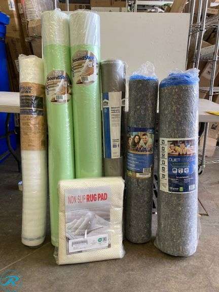 (7) New Assorted floor underlayment & rug pad (1) 100 sq ft quiet walk (1) 50 sq ft quiet walk (1) 100 sq ft protect source (2) 100 sq ft (e/ore) Sound step (1) 100 sq ft blue hawk (1) 6' x 9' rug pad - Roller Auctions