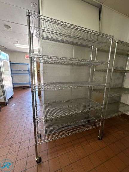 (2) Metal Wire Racks, 48” x 18” x 76”H and 48” x 18” x 74”H - Roller Auctions